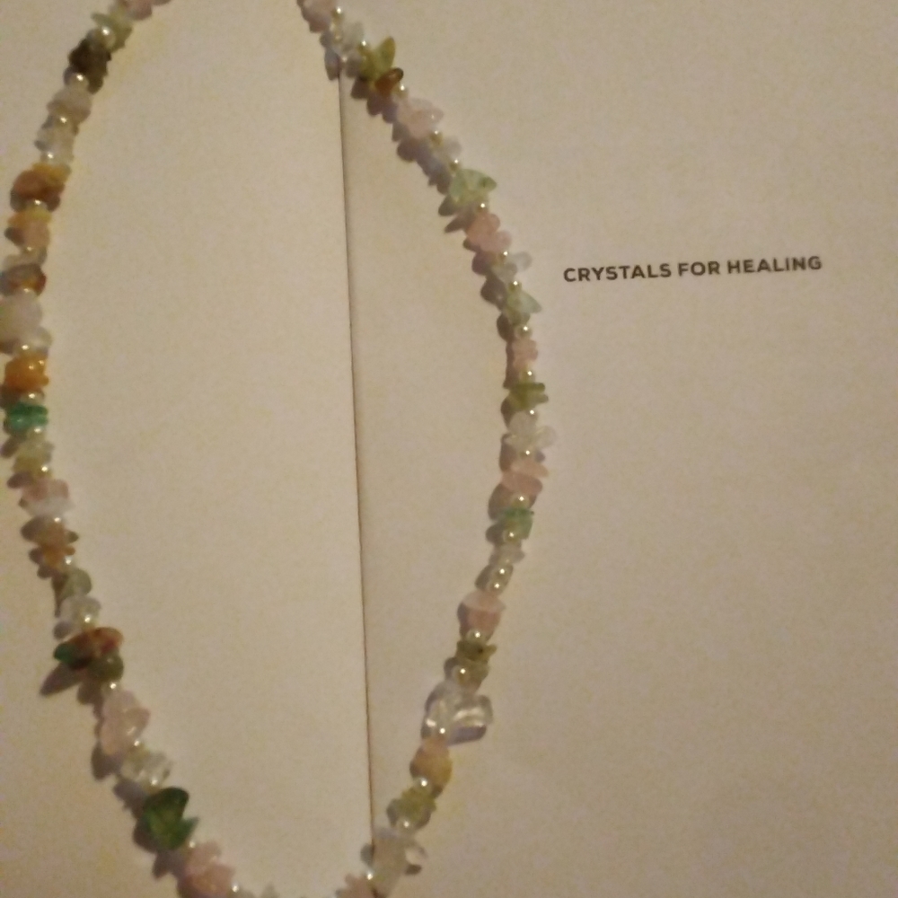 A handmade real crystal healing stone necklace mid length.